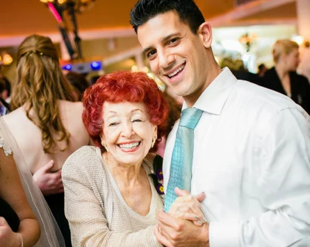 An older resident enjoying a joyful moment with a caregiver