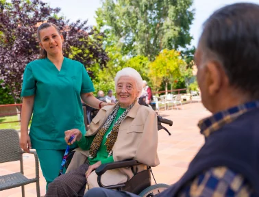 An older resident spending time outdoors with a caregiver