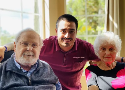 Residents enjoying a shared activity with a caregiver