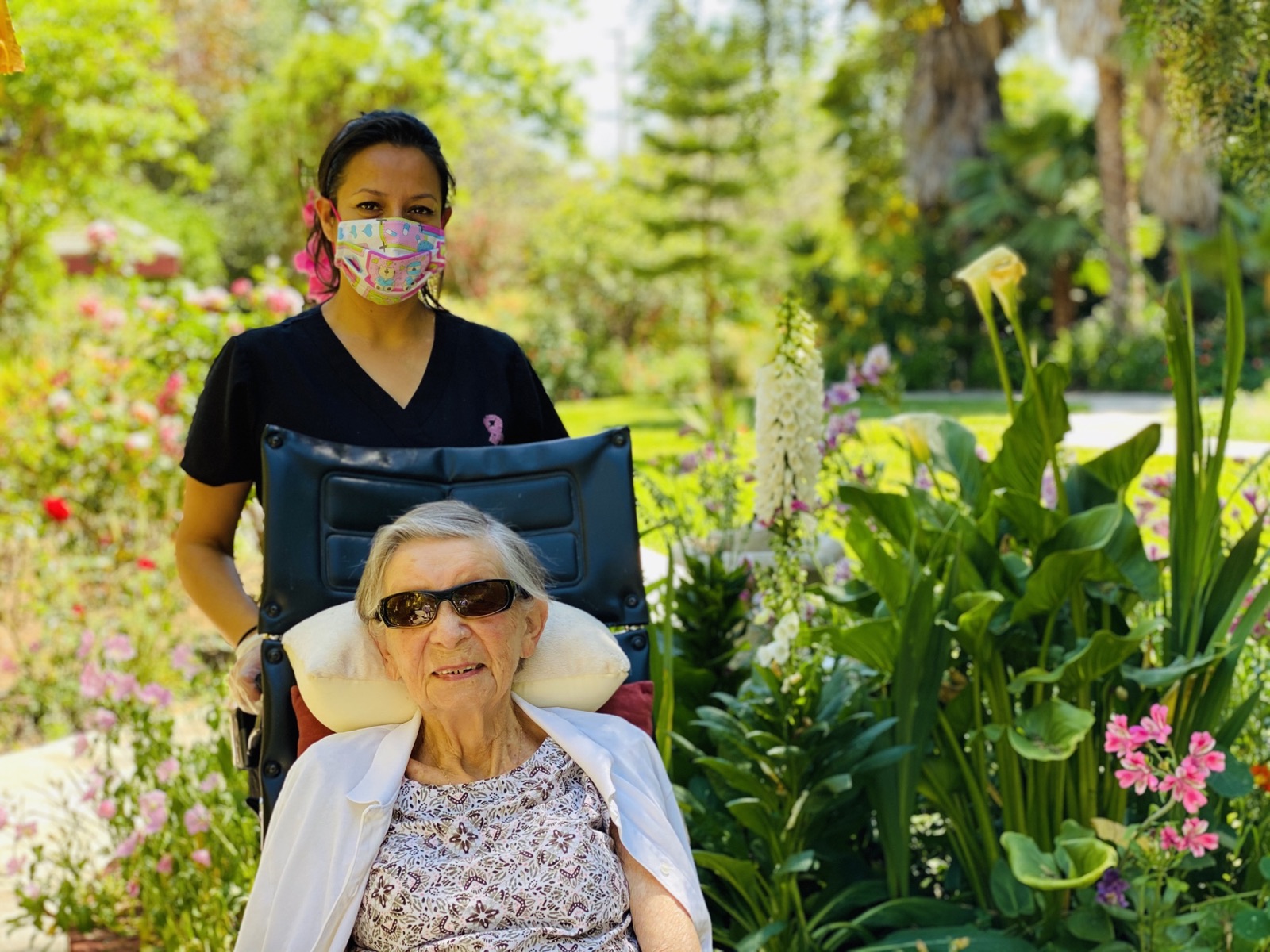 Resident enjoying the garden with a caregiver