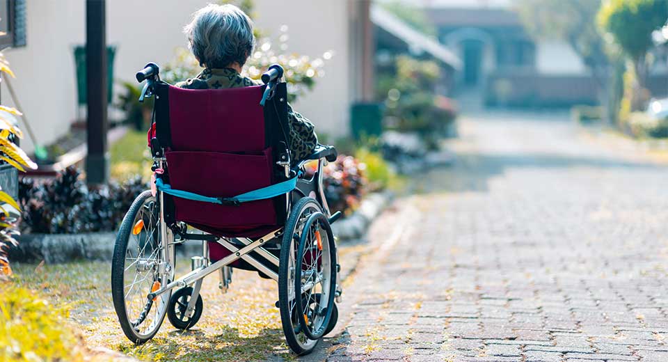 Old woman in wheelchair moving to Assisted Living Residence
